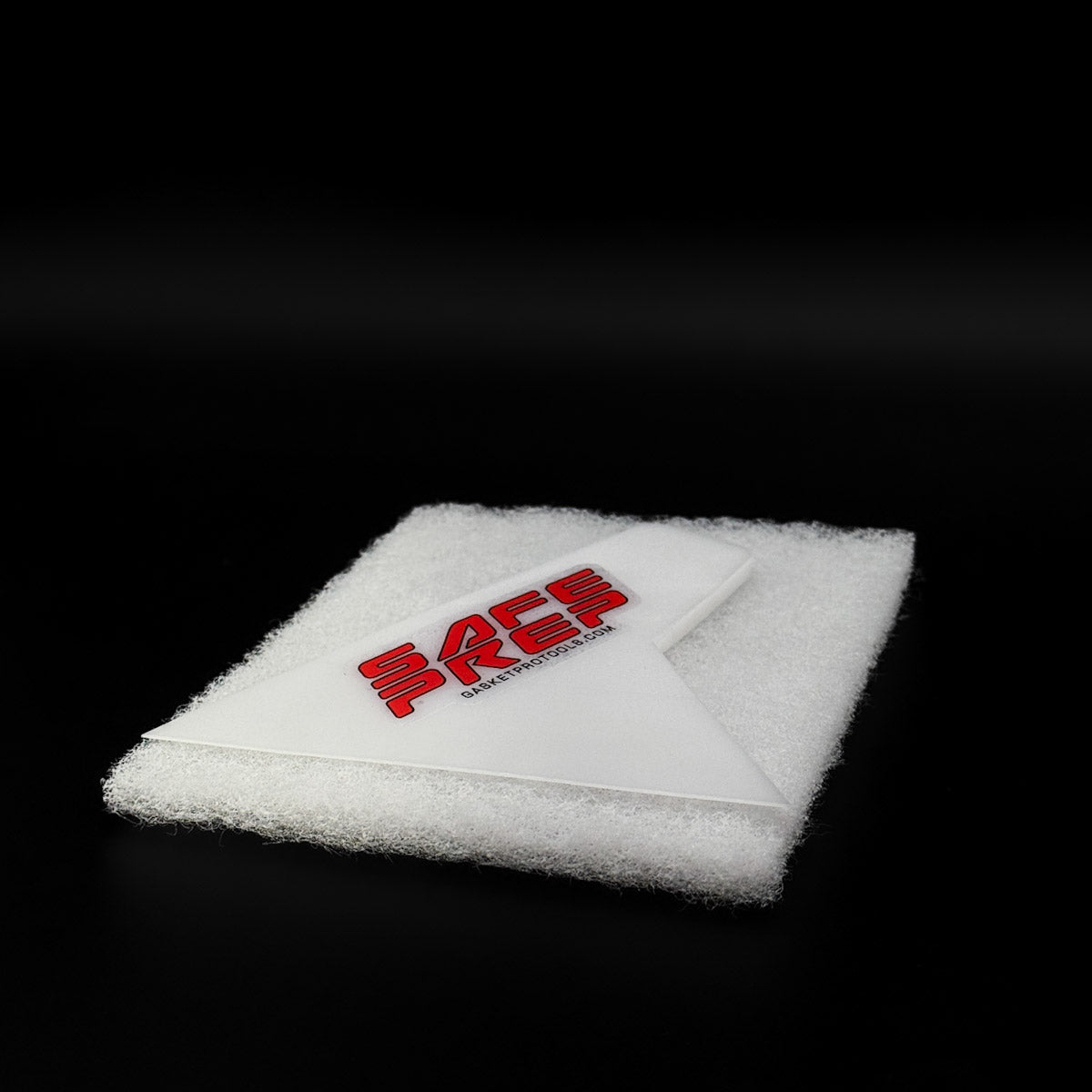 Close-up of Safe Prep Scraper for window tinting on black background, highlighting its durable hard plastic material and compact size.